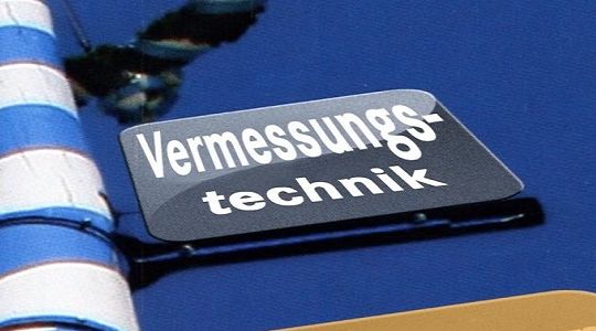 Teil eines Maibaums mit dem Schild Vermessungstechnik